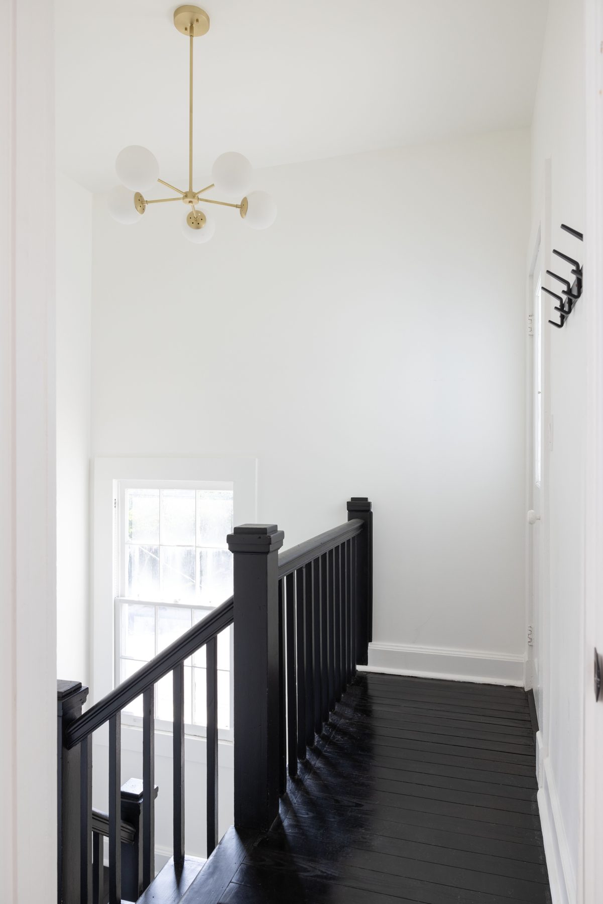 Carondelet stair landing with black rail